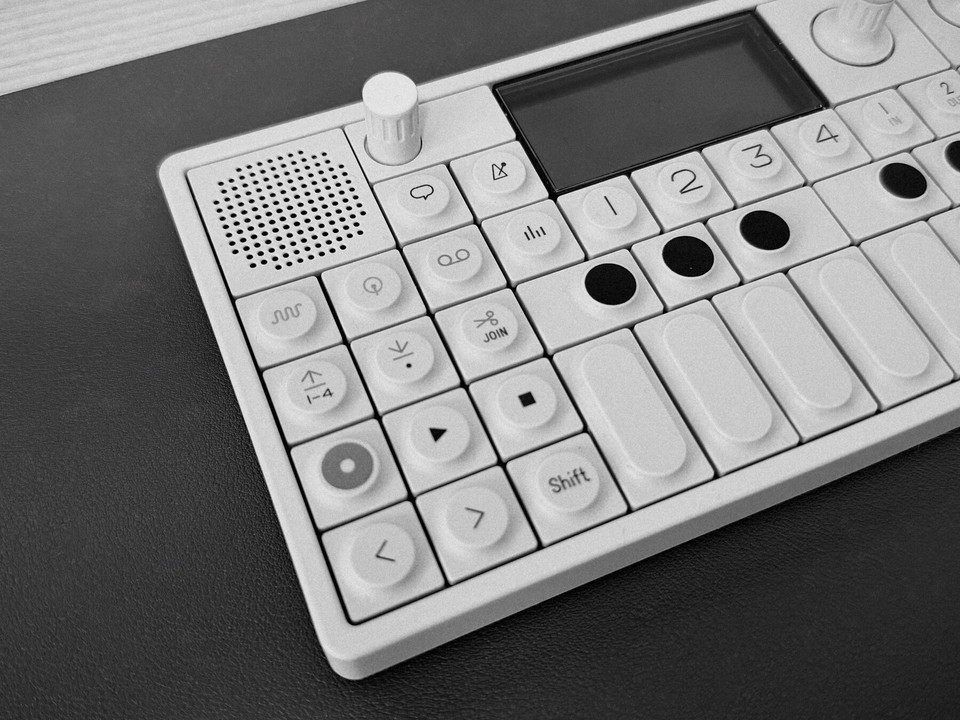 A compact synthesizer photographed in black and white